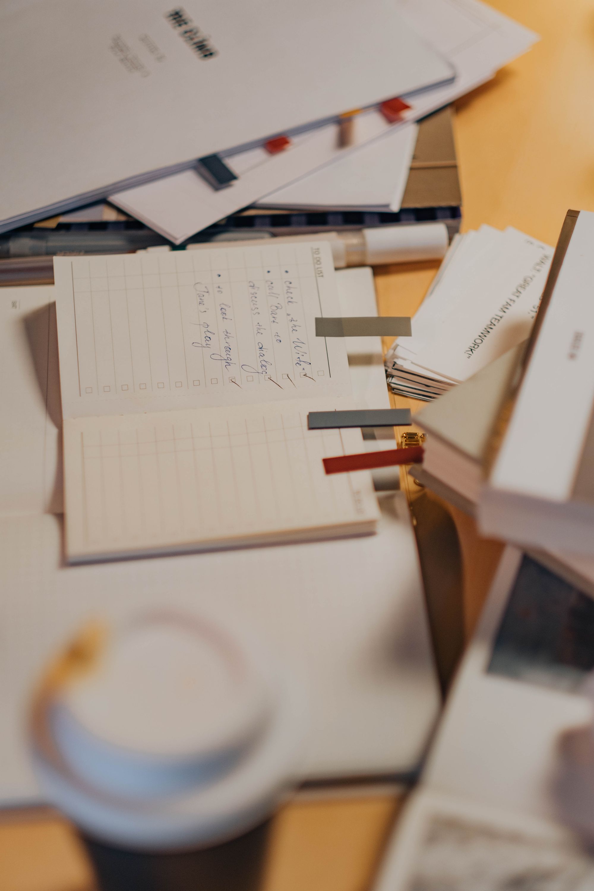Documents, notes, and planning materials arranged on a working desk.