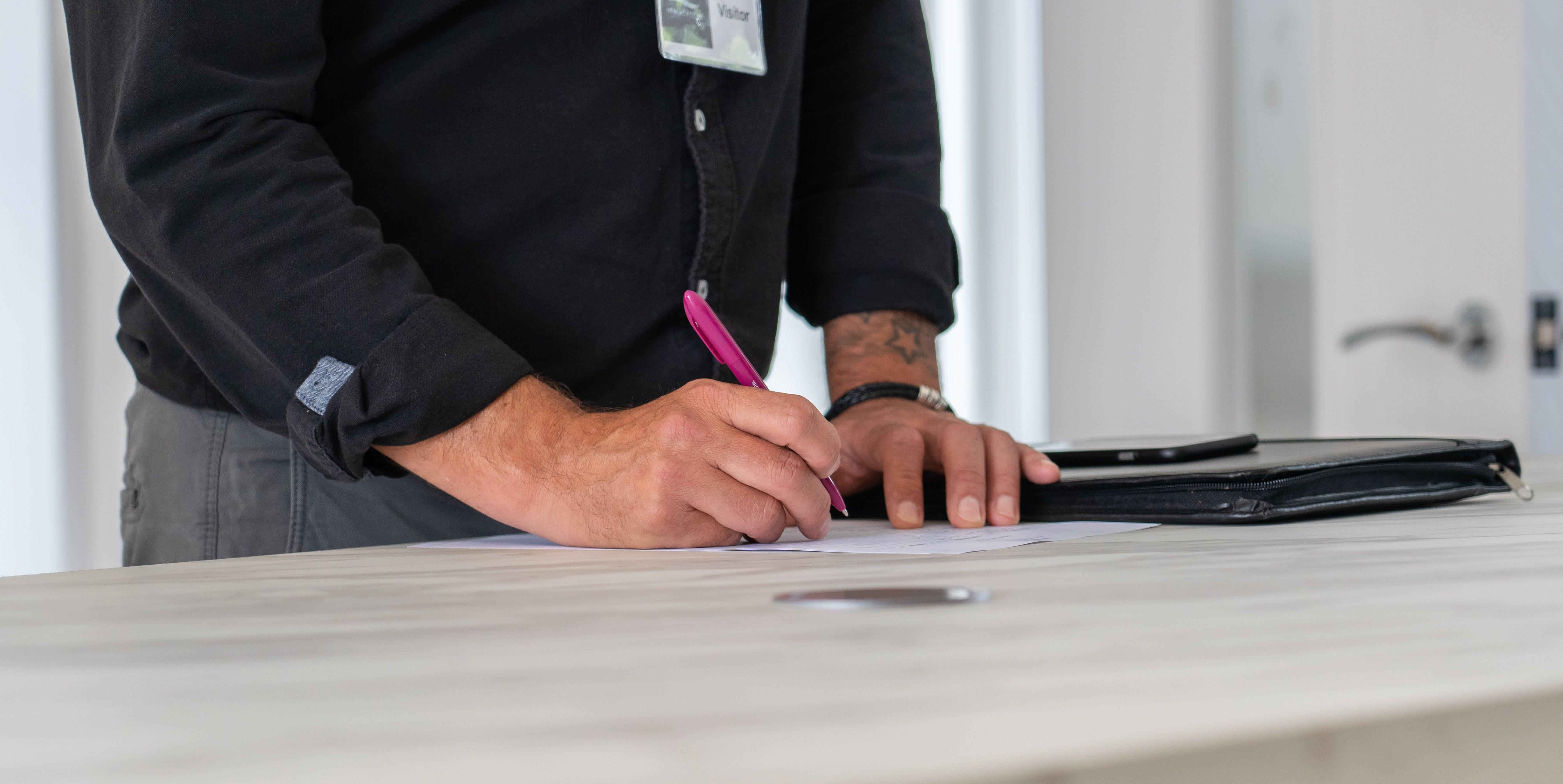A specialist reviewing and signing project documents.