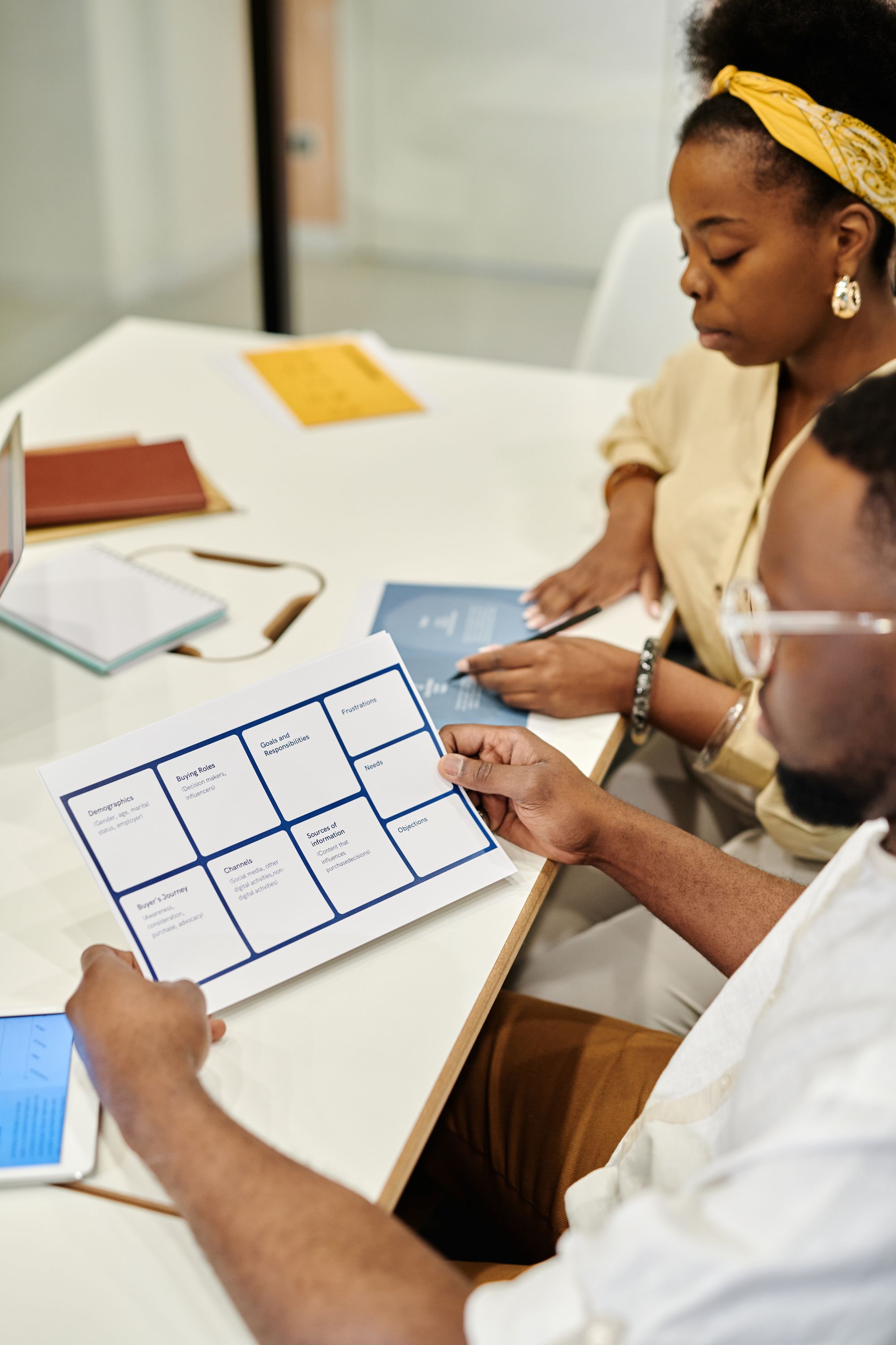 Professionals reviewing briefing papers during a working meeting.