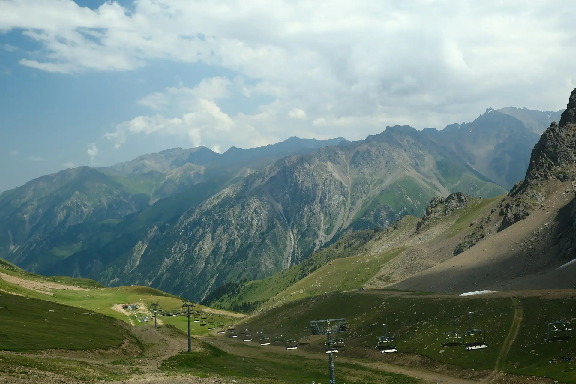 Green valley and mountain range near Almaty, Kazakhstan.