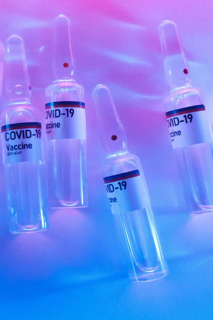 Vaccine vials in a scientific laboratory, illustrating cross-border health-policy research.