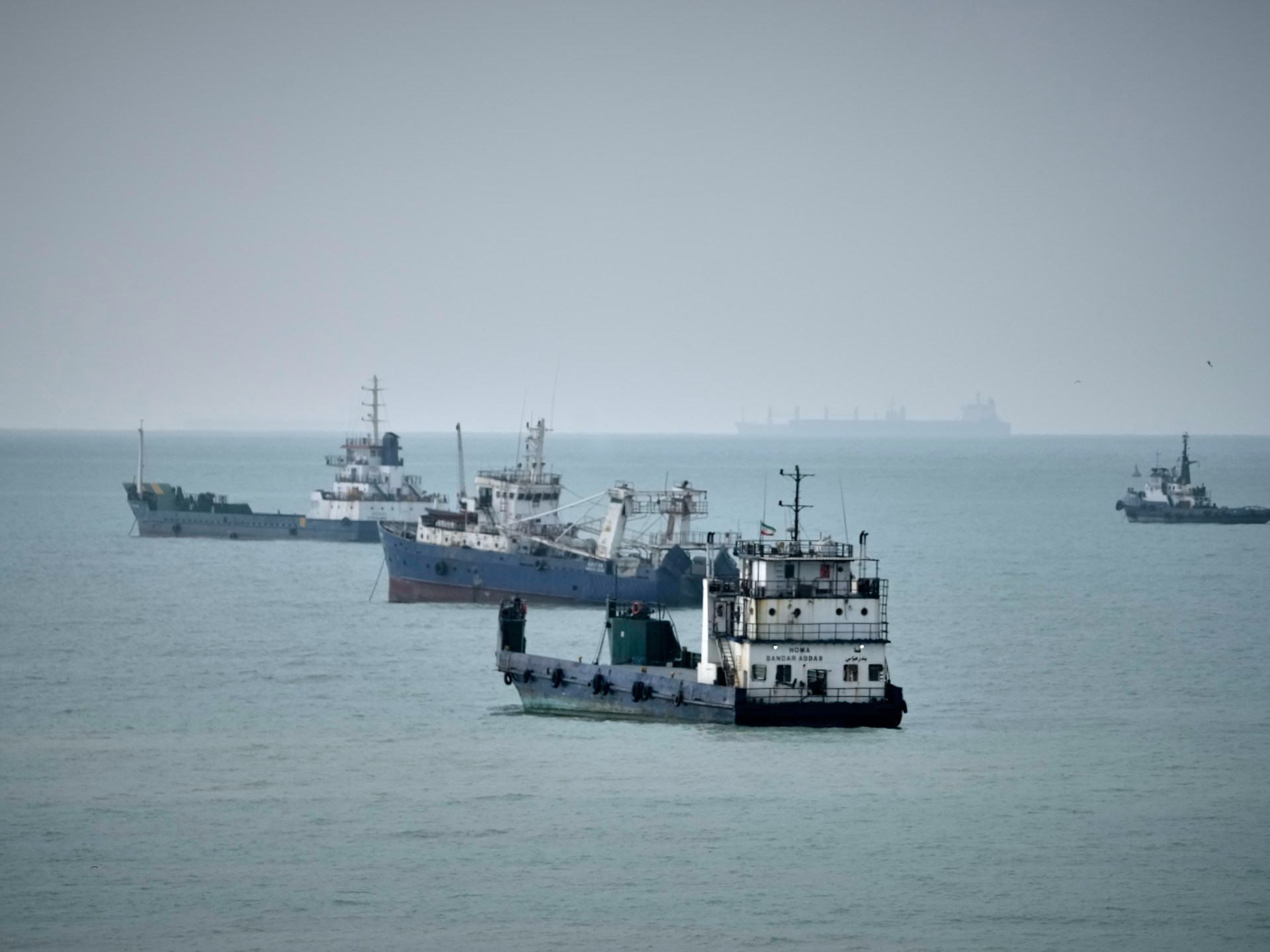 Commercial vessels lie anchored in the Strait of Hormuz off Bandar Abbas, Iran [Vahid Salemi/AP Photo]